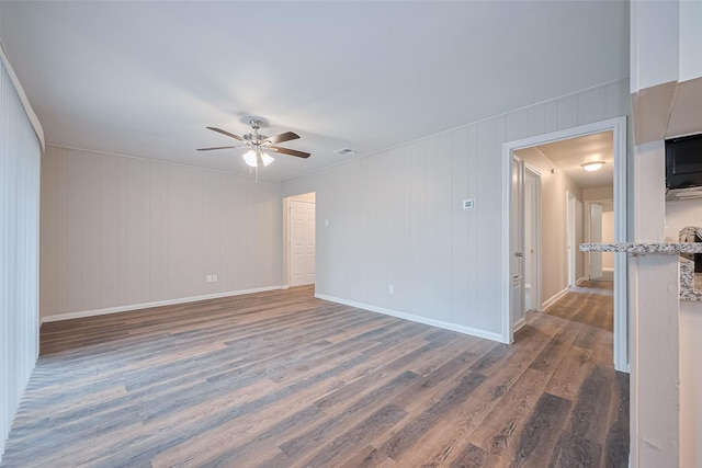 9003 Chateau Forest Dr, Houston, TX 77088 - empty room with a ceiling fan, dark wood-style floors, and baseboards