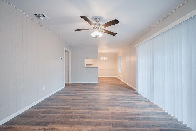 9003 Chateau Forest Dr, Houston, TX 77088 - unfurnished living room with ceiling fan, a chandelier, dark wood finished floors, and baseboards