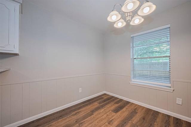 9003 Chateau Forest Dr, Houston, TX 77088 - unfurnished room featuring dark wood-style flooring, a chandelier, and wainscoting