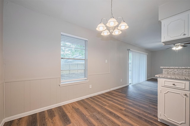 9003 Chateau Forest Dr, Houston, TX 77088 - unfurnished dining area featuring a chandelier, dark wood-type flooring, baseboards, and ceiling fan