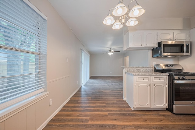 9003 Chateau Forest Dr, Houston, TX 77088 - kitchen featuring appliances with stainless steel finishes, a chandelier, white cabinets, dark wood-type flooring, and a ceiling fan
