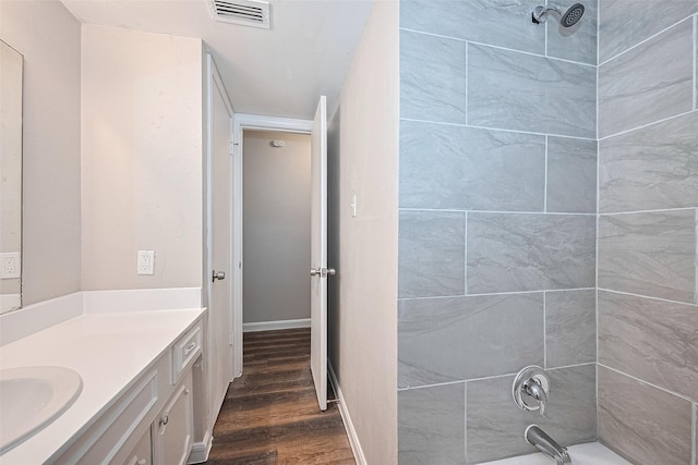 9003 Chateau Forest Dr, Houston, TX 77088 - full bath featuring wood finished floors, vanity, shower / washtub combination, and baseboards