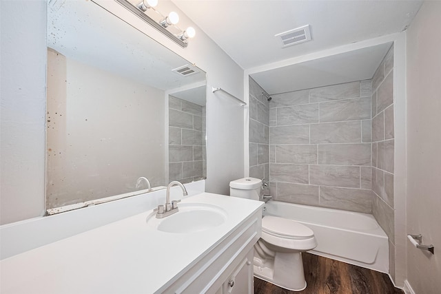 9003 Chateau Forest Dr, Houston, TX 77088 - bathroom featuring wood finished floors, vanity, toilet, and washtub / shower combination