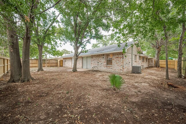9003 Chateau Forest Dr, Houston, TX 77088 - rear view of property with brick siding, a fenced backyard, and central air condition unit