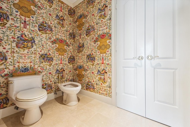 1000 Uptown Park Blvd Unit 181, Houston, TX 77056 - bathroom featuring baseboards, wallpapered walls, a bidet, toilet, and tile patterned flooring
