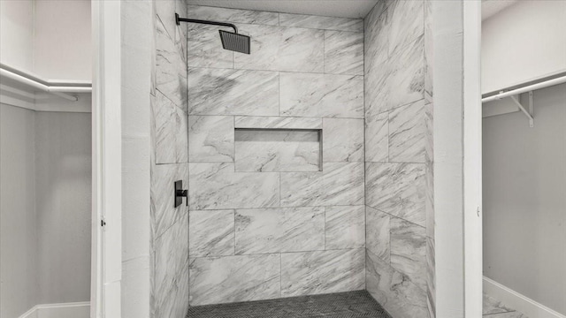 10622 Highland Woods Dr, Sugar Land, TX 77498 - full bathroom with a shower stall, baseboards, marble finish floors, and a walk in closet