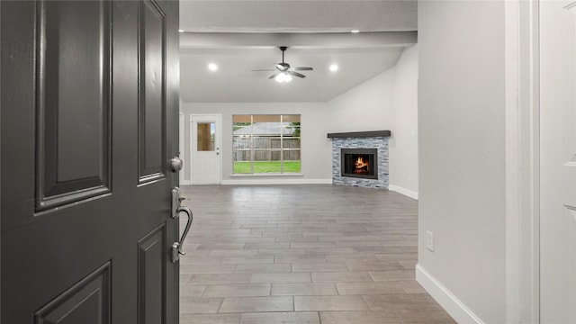 10622 Highland Woods Dr, Sugar Land, TX 77498 - entrance foyer with baseboards, wood finished floors, a ceiling fan, lofted ceiling, and a stone fireplace