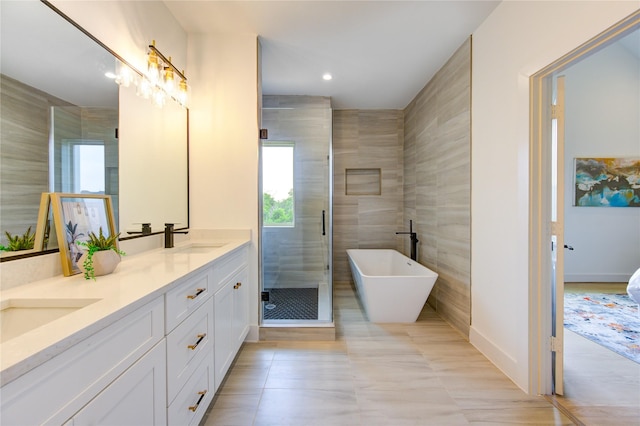 2310 Reinerman St, Houston, TX 77007 - full bathroom with double vanity, a soaking tub, a stall shower, recessed lighting, and tile patterned flooring