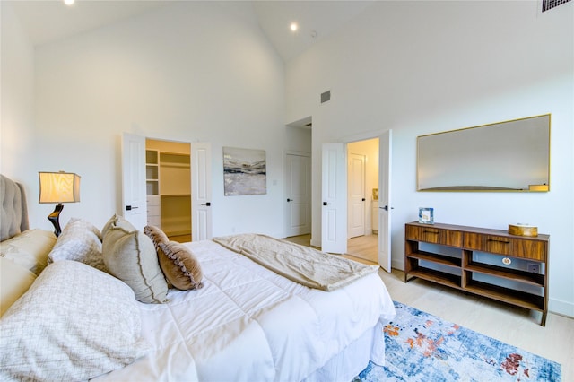 2310 Reinerman St, Houston, TX 77007 - bedroom featuring light wood-type flooring, high vaulted ceiling, recessed lighting, and a walk in closet