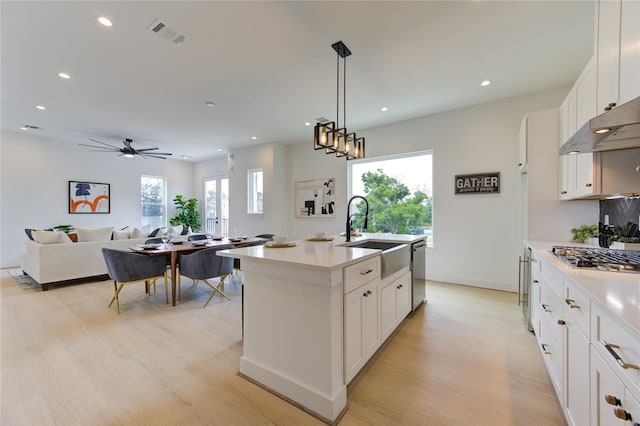 2310 Reinerman St, Houston, TX 77007 - kitchen featuring a sink, appliances with stainless steel finishes, light wood-style flooring, recessed lighting, and light countertops