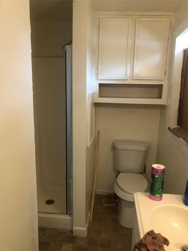 409 7th St, Huntsville, TX 77320 - bathroom with a shower stall, vanity, and toilet
