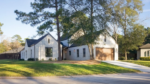 4785 W Fork Blvd, Conroe, TX 77304 - view of front of home with driveway, a front yard, and an attached garage