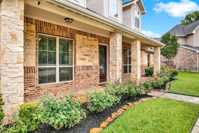 12406 Fort Isabella Ct, Tomball, TX 77375 - doorway to property with stone siding, a yard, and a porch