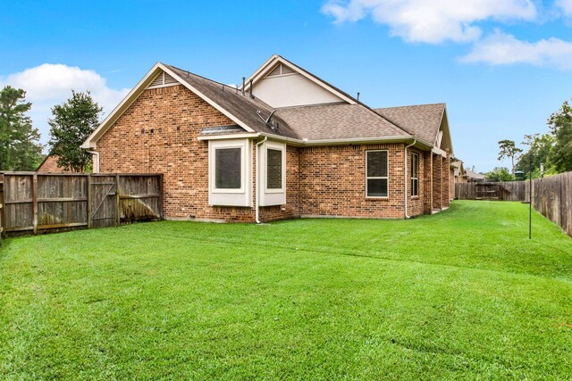 12406 Fort Isabella Ct, Tomball, TX 77375 - rear view of property featuring brick siding and roof with shingles
