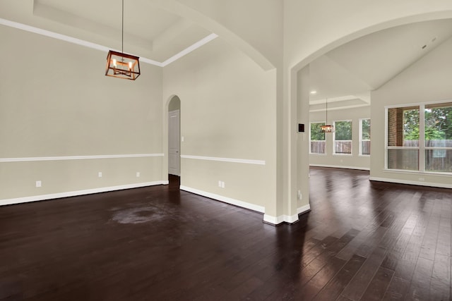 12406 Fort Isabella Ct, Tomball, TX 77375 - unfurnished room featuring arched walkways, high vaulted ceiling, dark wood finished floors, a chandelier, and baseboards