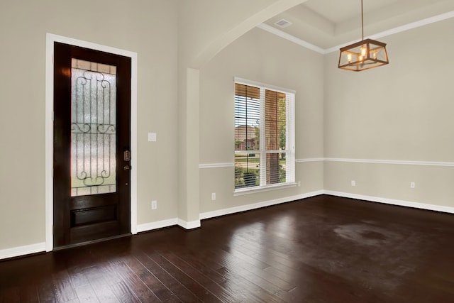 12406 Fort Isabella Ct, Tomball, TX 77375 - foyer featuring a chandelier, arched walkways, wood-type flooring, baseboards, and ornamental molding