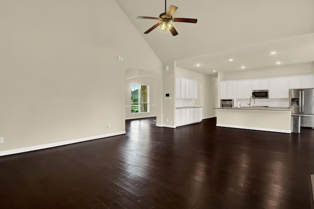 12406 Fort Isabella Ct, Tomball, TX 77375 - unfurnished living room featuring high vaulted ceiling, a ceiling fan, dark wood-style flooring, recessed lighting, and baseboards