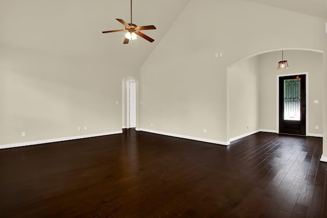 12406 Fort Isabella Ct, Tomball, TX 77375 - unfurnished living room with arched walkways, high vaulted ceiling, dark wood-type flooring, a ceiling fan, and baseboards