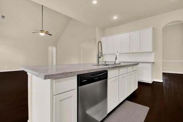 12406 Fort Isabella Ct, Tomball, TX 77375 - kitchen with stainless steel dishwasher, arched walkways, a sink, dark wood finished floors, and recessed lighting