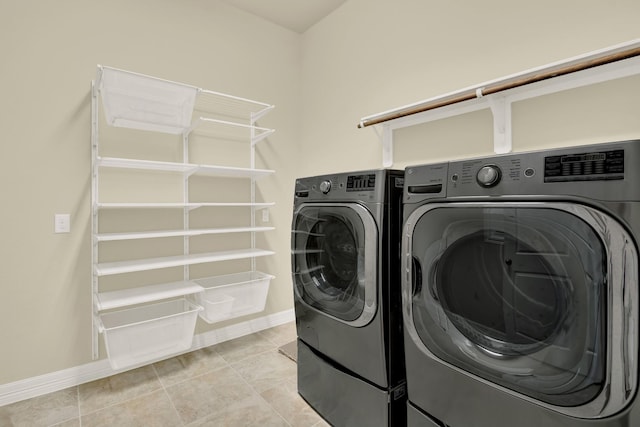 12406 Fort Isabella Ct, Tomball, TX 77375 - laundry room with washing machine and clothes dryer, baseboards, and light tile patterned floors