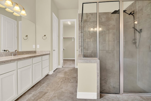 12406 Fort Isabella Ct, Tomball, TX 77375 - bathroom with tiled shower, vanity, and a walk in closet