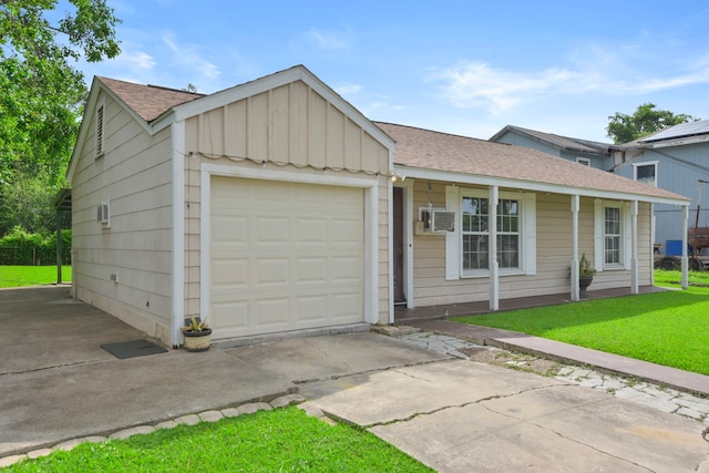 1900 Oregon St, Baytown, TX 77520 - ranch-style house featuring an attached garage, driveway, board and batten siding, a front lawn, and a shingled roof
