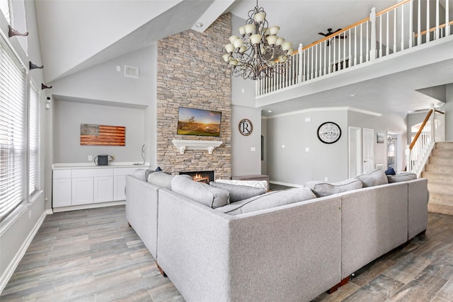 2907 Silverberry Trl, Houston, TX 77345 - living area featuring high vaulted ceiling, a fireplace, wood finished floors, stairs, and a chandelier