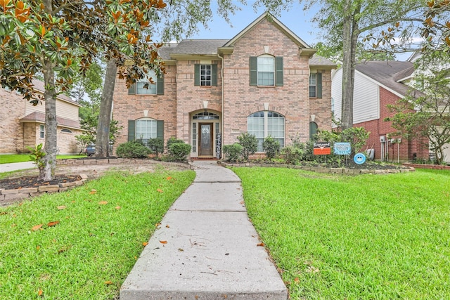 2907 Silverberry Trl, Houston, TX 77345 - traditional-style home featuring a front lawn and brick siding