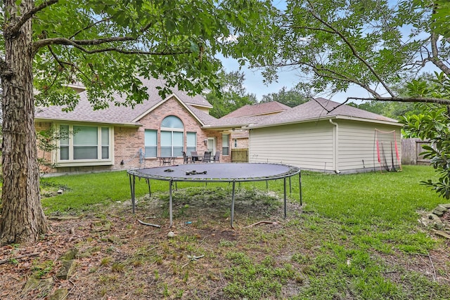 2907 Silverberry Trl, Houston, TX 77345 - rear view of house featuring a trampoline, roof with shingles, and brick siding
