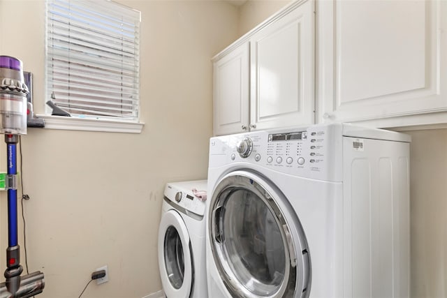 2907 Silverberry Trl, Houston, TX 77345 - laundry room featuring cabinet space and washing machine and clothes dryer