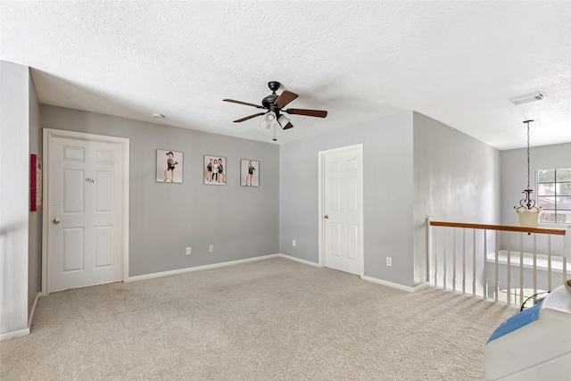 2907 Silverberry Trl, Houston, TX 77345 - spare room with ceiling fan, carpet flooring, baseboards, and a textured ceiling