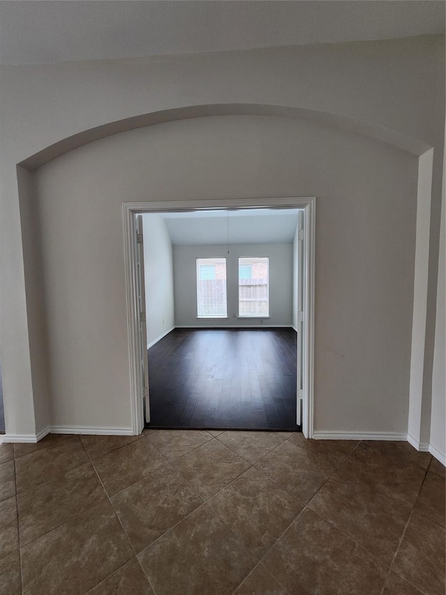 13705 Rainwater Dr, Pearland, TX 77584 - empty room featuring dark tile patterned floors and baseboards