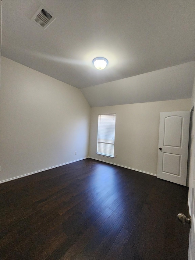 13705 Rainwater Dr, Pearland, TX 77584 - bonus room with dark wood-type flooring, vaulted ceiling, and baseboards