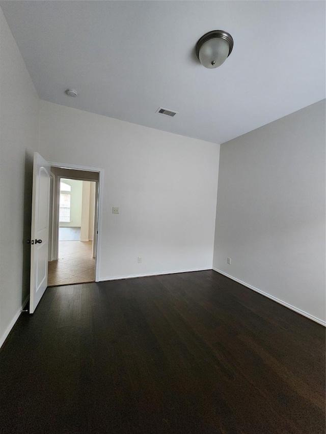 13705 Rainwater Dr, Pearland, TX 77584 - unfurnished room with dark wood-style flooring, baseboards, and a smoke detector