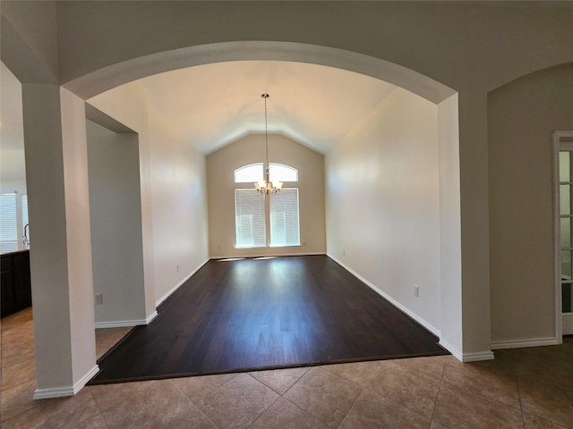13705 Rainwater Dr, Pearland, TX 77584 - unfurnished dining area with plenty of natural light, lofted ceiling, a chandelier, tile patterned flooring, and arched walkways