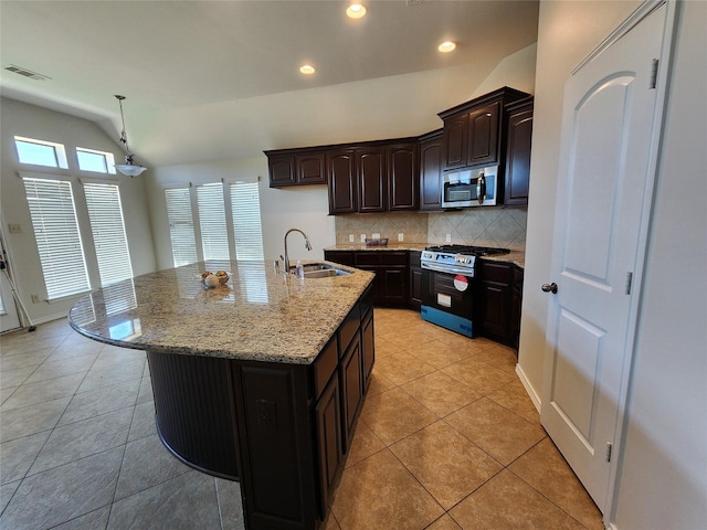 13705 Rainwater Dr, Pearland, TX 77584 - kitchen featuring stainless steel appliances, a sink, backsplash, lofted ceiling, and recessed lighting