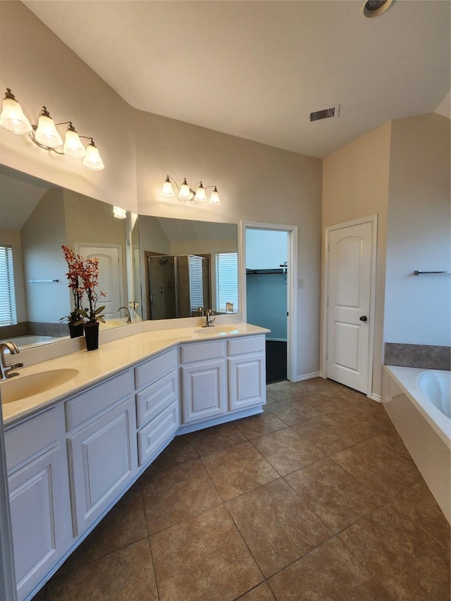 13705 Rainwater Dr, Pearland, TX 77584 - bathroom featuring a shower stall, double vanity, a bath, and tile patterned floors