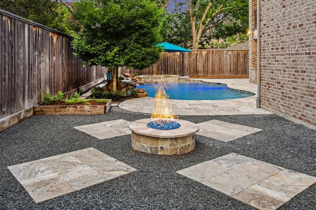 12710 Pebblebrook Dr, Houston, TX 77024 - view of pool featuring a fenced backyard, a fire pit, a patio area, and a pool with connected hot tub