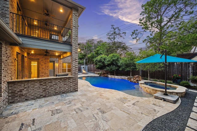 12710 Pebblebrook Dr, Houston, TX 77024 - view of swimming pool with a ceiling fan, a patio, a fenced backyard, and a pool with connected hot tub