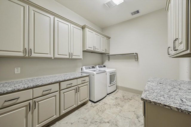 12710 Pebblebrook Dr, Houston, TX 77024 - laundry area featuring cabinet space, washer and dryer, and baseboards
