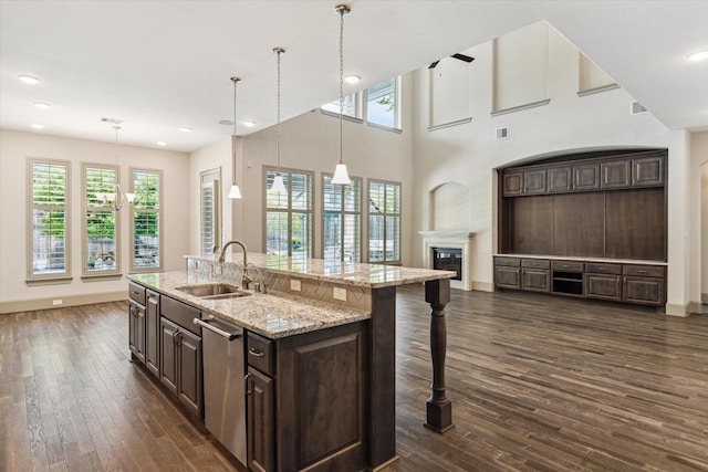 12710 Pebblebrook Dr, Houston, TX 77024 - kitchen with a sink, dishwasher, plenty of natural light, dark brown cabinets, and recessed lighting