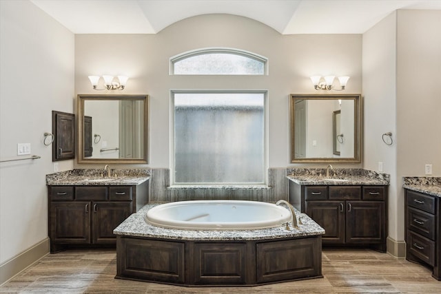 12710 Pebblebrook Dr, Houston, TX 77024 - full bath featuring a chandelier, two vanities, and a garden tub