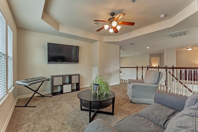 25322 Metzler Creek Dr, Spring, TX 77389 - carpeted living area with a ceiling fan, a tray ceiling, and baseboards