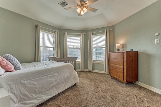 25322 Metzler Creek Dr, Spring, TX 77389 - carpeted bedroom with baseboards, a tray ceiling, a textured wall, and ceiling fan