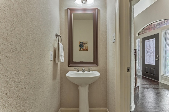25322 Metzler Creek Dr, Spring, TX 77389 - bathroom with a textured wall, baseboards, and wood finished floors