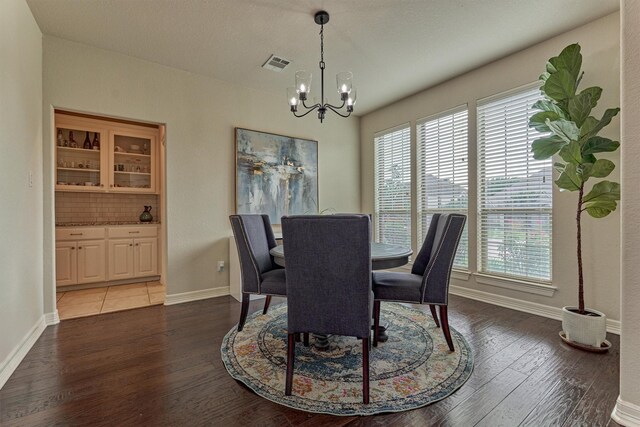 25322 Metzler Creek Dr, Spring, TX 77389 - dining space with a chandelier, plenty of natural light, wood finished floors, and baseboards