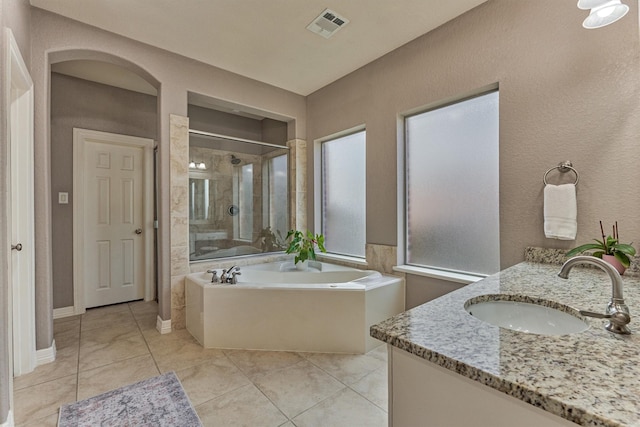 25322 Metzler Creek Dr, Spring, TX 77389 - bathroom with double vanity, a garden tub, a stall shower, and tile patterned flooring
