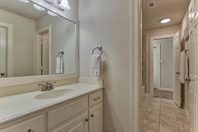25322 Metzler Creek Dr, Spring, TX 77389 - bathroom featuring vanity, tile patterned floors, and a textured wall