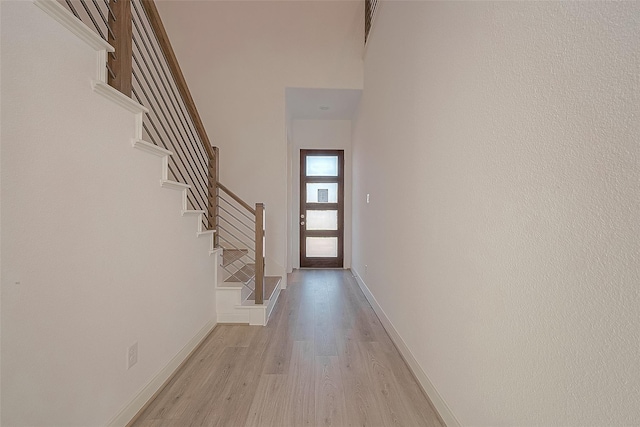 8918 Grovner Pl, Houston, TX 77055 - entrance foyer with light wood-style floors, stairs, baseboards, and a towering ceiling