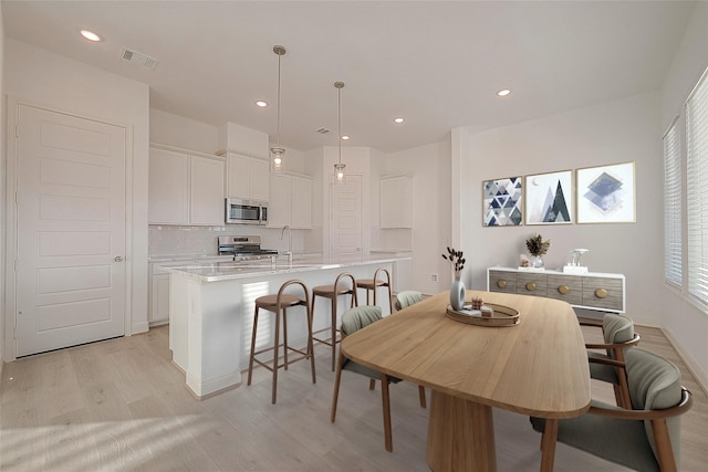8918 Grovner Pl, Houston, TX 77055 - dining area featuring light wood-type flooring and recessed lighting